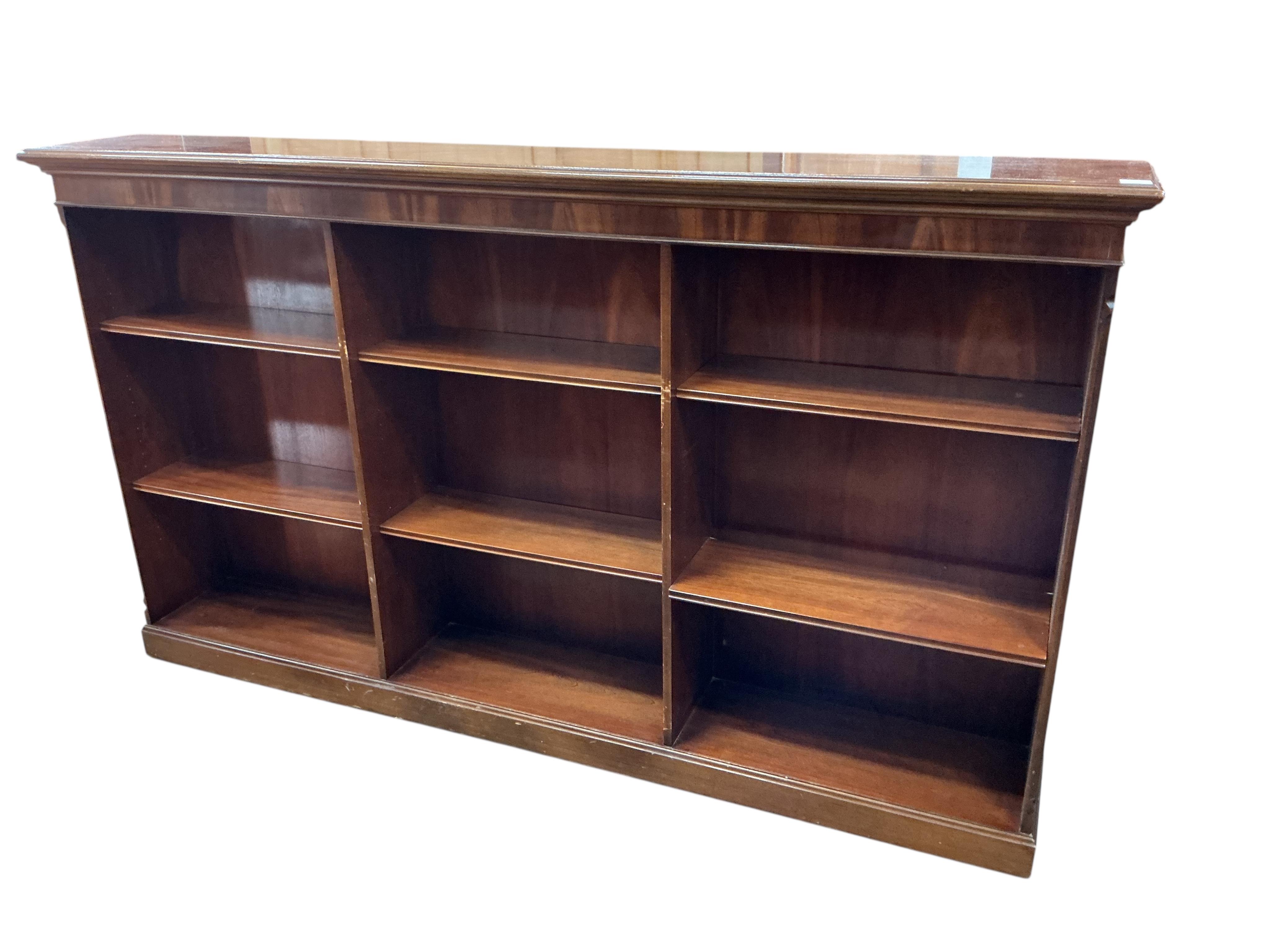 A reproduction mahogany dwarf open bookcase, width 214cm, depth 32cm, height 124cm